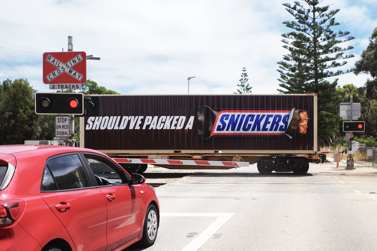 SNICKERS transforms a WA freight train into a moving billboard on rails via T&P Australia